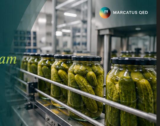 Jars of pickles moving along a co-packing line