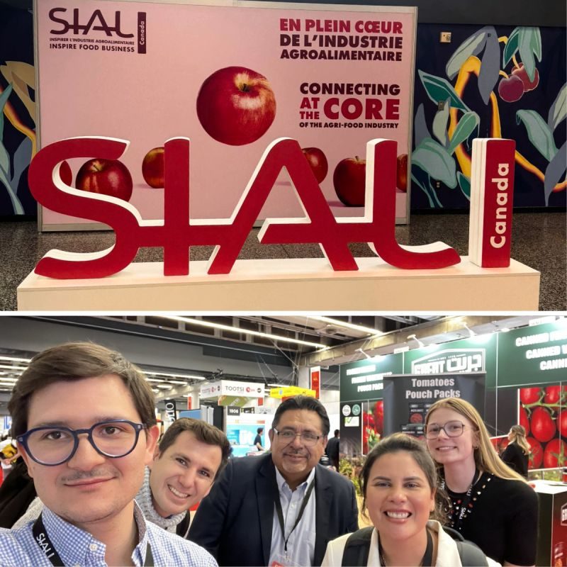 The SIAL Canada sign on the exhibition floor, above the Marcatus QED team at the show